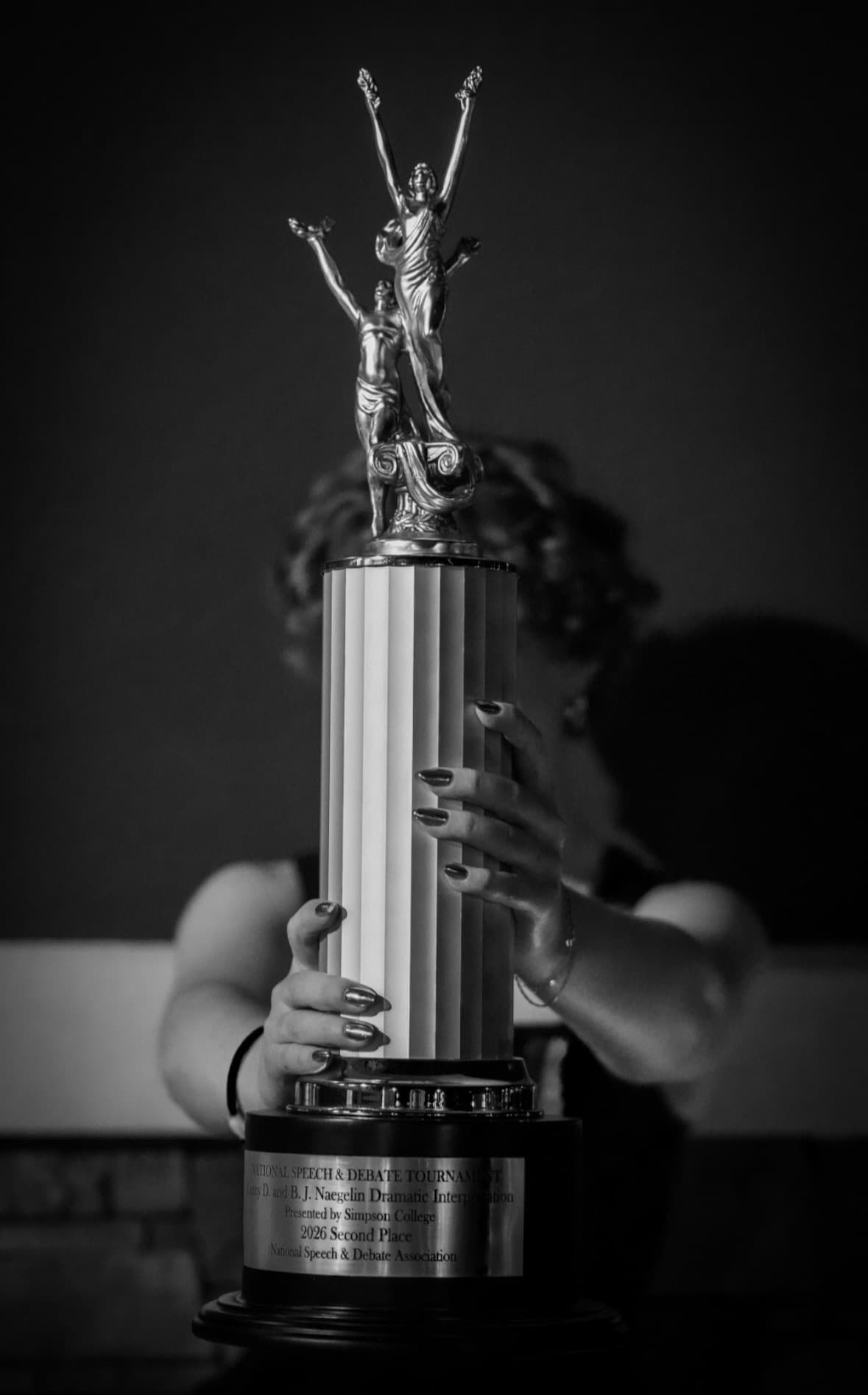 Tessa Fulcher holding her national runner-up trophy at the 2026 NSDA National Tournament